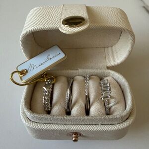 Silver adjustable cubic zirconia ring set in a cream jewelry case.